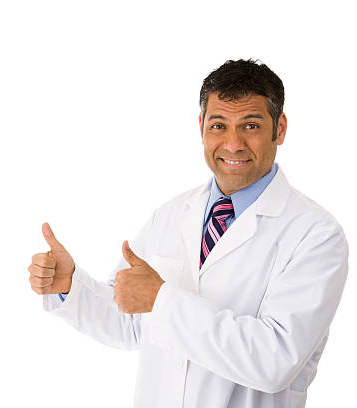 Dentist giving two thumbs up and smiling